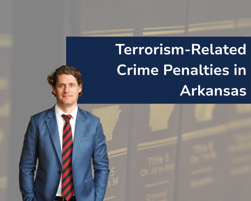 Criminal attorney Kale Ludwig in blue suit with red tie in the foreground, close-up of the Arkansas Code Annotated in the background.